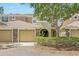 Charming townhome featuring stone accents, attached garage, and manicured landscaping at 8125 Stone Path Way, Tampa, FL 33647