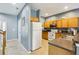 Well-lit kitchen with wooden cabinets, white appliances, and tile flooring at 8125 Stone Path Way, Tampa, FL 33647