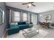 Bright, open living room featuring a modern sectional sofa and adjacent dining area at 8125 Stone Path Way, Tampa, FL 33647