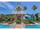 Inviting community pool with a thrilling waterslide and tower amidst lush landscaping at 8125 Stone Path Way, Tampa, FL 33647