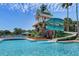 Community pool with waterslide and tower on a bright and sunny day at 8125 Stone Path Way, Tampa, FL 33647