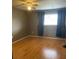 This bedroom has hardwood floors, a ceiling fan, and neutral paint tones at 825 S Village N Dr # 201, St Petersburg, FL 33716