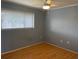 A bright bedroom featuring natural light, hardwood floors, and neutral colors at 825 S Village N Dr # 201, St Petersburg, FL 33716