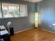 Cozy bedroom with wood laminate flooring and natural light at 825 S Village N Dr # 201, St Petersburg, FL 33716
