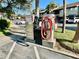 Foam & Spray car wash station with vacuum cleaner hose and trash can in an outdoor parking lot at 825 S Village N Dr # 201, St Petersburg, FL 33716