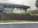 Exterior of a townhouse with a balcony and fenced backyard at 825 S Village N Dr # 201, St Petersburg, FL 33716
