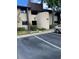Building exterior featuring clean landscaping and a dedicated parking space for residents and guests at 825 S Village N Dr # 201, St Petersburg, FL 33716