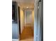 Bright hallway featuring lovely flooring and white doors, offering passage to various rooms at 825 S Village N Dr # 201, St Petersburg, FL 33716