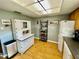 Charming kitchen featuring a vintage hutch, modern appliances, and bright, sunny ambience at 825 S Village N Dr # 201, St Petersburg, FL 33716