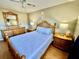 A spacious main bedroom with hardwood floors and matching furniture at 825 S Village N Dr # 201, St Petersburg, FL 33716