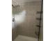 A tiled walk-in shower with adjustable shower head and corner caddy at 825 S Village N Dr # 201, St Petersburg, FL 33716