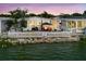 Charming waterfront home with a white picket fence, gazebo, and multiple seating areas overlooking the water at 8444 Fantasia Park Way, Riverview, FL 33578