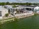 A waterfront home features a patio, gazebo, white picket fence and direct water access for easy enjoyment at 8444 Fantasia Park Way, Riverview, FL 33578