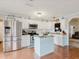 Modern kitchen with stainless steel appliances, white cabinets, and a central island with seating at 8444 Fantasia Park Way, Riverview, FL 33578