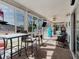 Spacious sunroom with plenty of seating and beautiful views of the surrounding landscape and lake at 8444 Fantasia Park Way, Riverview, FL 33578