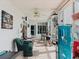 Bright sunroom with comfortable seating and games overlooking the backyard at 8444 Fantasia Park Way, Riverview, FL 33578