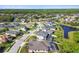 An aerial view of a neighborhood, showcasing homes near a lake and surrounded by mature landscaping at 8628 Eagle Brook Dr, Land O Lakes, FL 34638