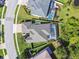 Aerial view showcases a home with a screened pool, lush landscaping, and a well-maintained roof at 8628 Eagle Brook Dr, Land O Lakes, FL 34638