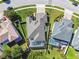 Aerial view showcases a home with a screened pool, lush landscaping, and a well-maintained roof at 8628 Eagle Brook Dr, Land O Lakes, FL 34638