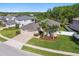 Aerial view of home featuring manicured lawn, mature palm trees, and a paved driveway at 8628 Eagle Brook Dr, Land O Lakes, FL 34638