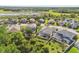 This aerial view displays a home with screened-in pool, a manicured lawn, and a white picket fence at 8628 Eagle Brook Dr, Land O Lakes, FL 34638