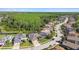 An aerial view reveals a home surrounded by lush green trees and landscaping near a lake at 8628 Eagle Brook Dr, Land O Lakes, FL 34638