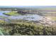 An aerial shot depicts expansive wetlands and marshlands, reflecting the sunlight at 8628 Eagle Brook Dr, Land O Lakes, FL 34638