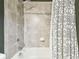 Close-up of shower featuring tile surround, shower head, and patterned shower curtain at 8628 Eagle Brook Dr, Land O Lakes, FL 34638