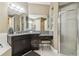 Bathroom featuring a dark vanity with granite countertops and a glass-enclosed shower at 8628 Eagle Brook Dr, Land O Lakes, FL 34638