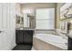 Bathroom highlighting a vanity with granite countertops and a soaking tub at 8628 Eagle Brook Dr, Land O Lakes, FL 34638