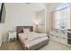 Well-lit bedroom with carpet, large window, side table, and decor at 8628 Eagle Brook Dr, Land O Lakes, FL 34638