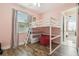 Pink ' room with loft bed, red beanbag, and wood-look flooring at 8628 Eagle Brook Dr, Land O Lakes, FL 34638