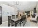 Dining area featuring dark wood furniture, modern chandelier, and an open view to the kitchen and living spaces at 8628 Eagle Brook Dr, Land O Lakes, FL 34638
