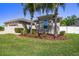 Lovely home showcasing lush landscaping, mature palm trees, and an attached two car garage at 8628 Eagle Brook Dr, Land O Lakes, FL 34638