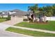 Well maintained single-Gathering home featuring a three car garage, tidy landscaping, and curb appeal at 8628 Eagle Brook Dr, Land O Lakes, FL 34638