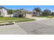 Single-Gathering home with three-car garage, side yard, mature landscaping, and brick paver driveway at 8628 Eagle Brook Dr, Land O Lakes, FL 34638