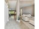 Inviting foyer with tile flooring, neutral walls, and view into the living room with large windows at 8628 Eagle Brook Dr, Land O Lakes, FL 34638