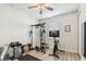 Home gym with fitness machine, TV, weights, and fan at 8628 Eagle Brook Dr, Land O Lakes, FL 34638