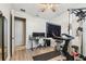 Home gym featuring fitness machine, TV, weights, fan, and desk setup at 8628 Eagle Brook Dr, Land O Lakes, FL 34638