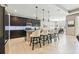 Kitchen with dark wood cabinets, stainless steel appliances, granite countertops, and open dining area at 8628 Eagle Brook Dr, Land O Lakes, FL 34638