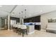 Spacious kitchen island with bar stool seating, dark cabinets, and modern lighting fixtures at 8628 Eagle Brook Dr, Land O Lakes, FL 34638
