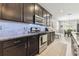 Stylish kitchen with dark wood cabinets, stainless steel appliances, and tile backsplash at 8628 Eagle Brook Dr, Land O Lakes, FL 34638