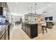 Open kitchen with dark cabinets, granite countertops, a large island, and adjacent dining area at 8628 Eagle Brook Dr, Land O Lakes, FL 34638