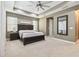 This primary bedroom features a tray ceiling, neutral tones, and ample natural light creating a serene atmosphere at 8628 Eagle Brook Dr, Land O Lakes, FL 34638