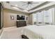 Spacious main bedroom featuring tray ceilings, neutral paint, carpet, and large windows with white curtains at 8628 Eagle Brook Dr, Land O Lakes, FL 34638