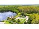 Aerial view of a lakeside park featuring a playground, dock, lawn, and picnic area at 8628 Eagle Brook Dr, Land O Lakes, FL 34638