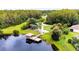 Aerial view of a park with a playground, walking paths and a covered dock by a lake at 8628 Eagle Brook Dr, Land O Lakes, FL 34638