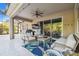 Covered patio with seating area, ceiling fan, TV, and view of the backyard at 8628 Eagle Brook Dr, Land O Lakes, FL 34638