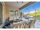 Screened-in porch with outdoor furniture and view of the pool at 8628 Eagle Brook Dr, Land O Lakes, FL 34638