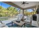 Covered patio with outdoor furniture, ceiling fan, and a view of the pool and backyard at 8628 Eagle Brook Dr, Land O Lakes, FL 34638